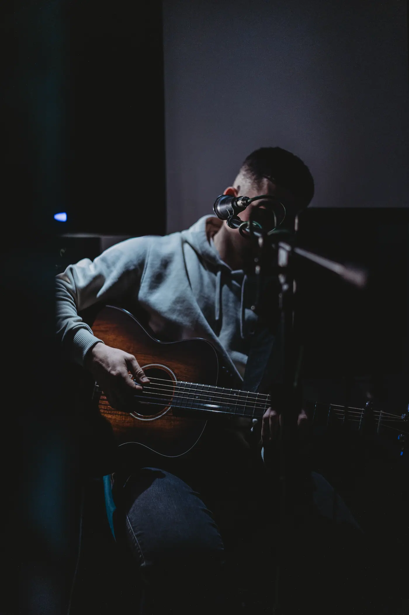 A singer with an acoustic guitar performing